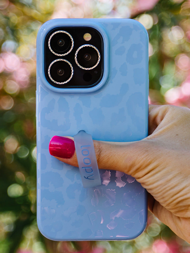 A woman holding a Periwinkle Leopard Loopy Case.|| feature-media