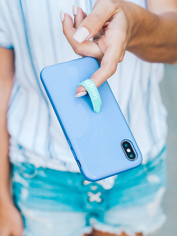 A woman holding a Periwinkle Loopy Case. || feature-media