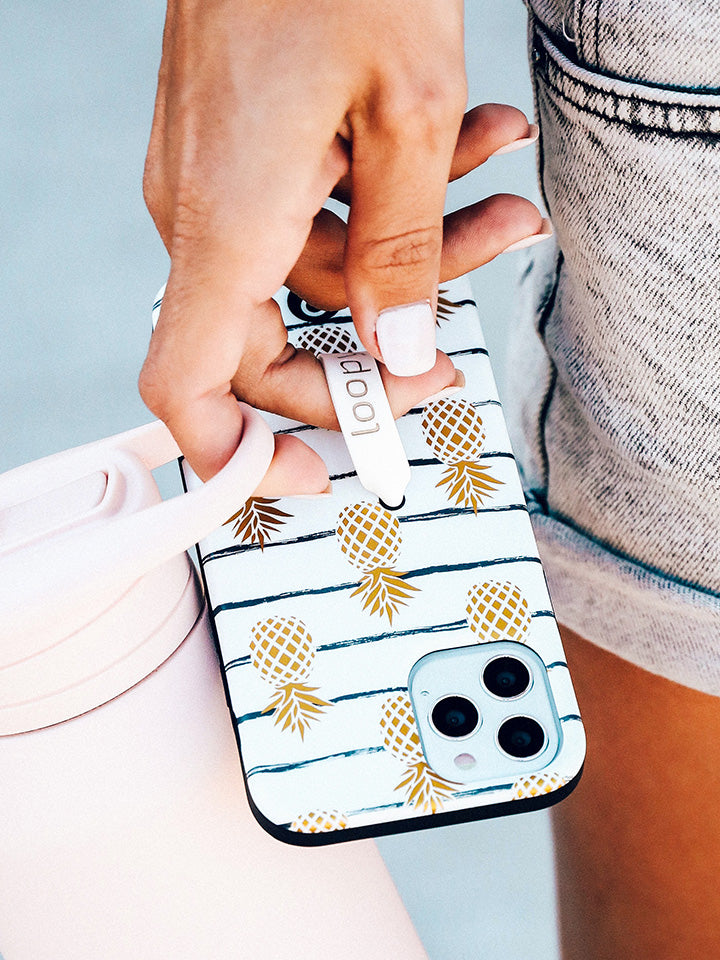 A woman holding a Pineapple Loopy Case. || feature-media