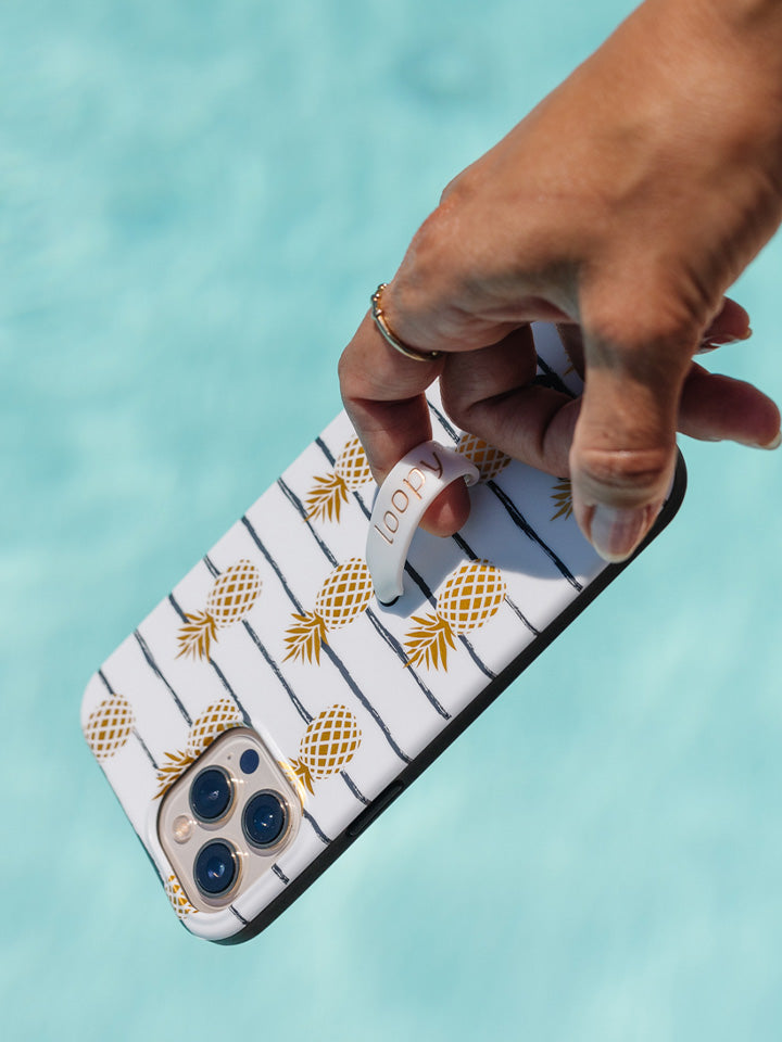 A woman holding a Pineapple Loopy Case. || feature-media