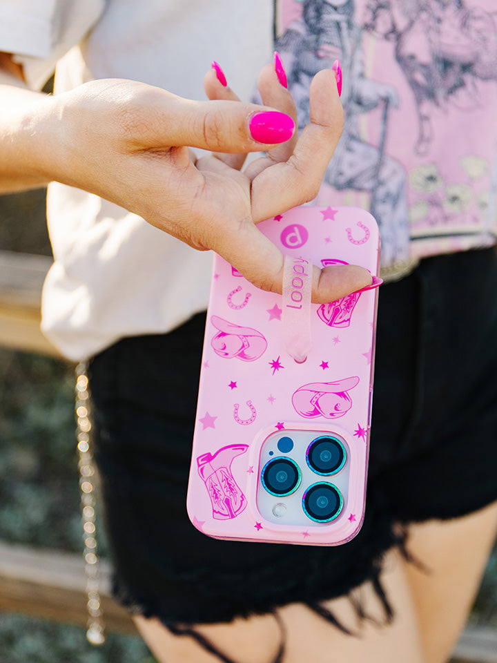 A woman holding a Pink Boots Loopy Case.|| feature-media