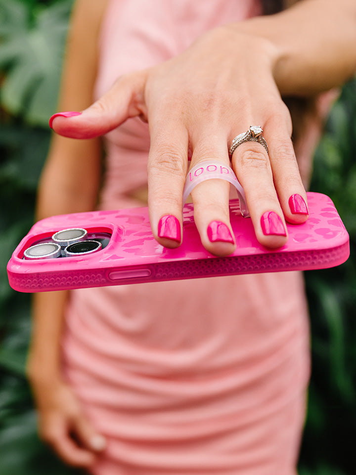 A woman holding a Hot Pink Leopard Loopy Case. || feature-media