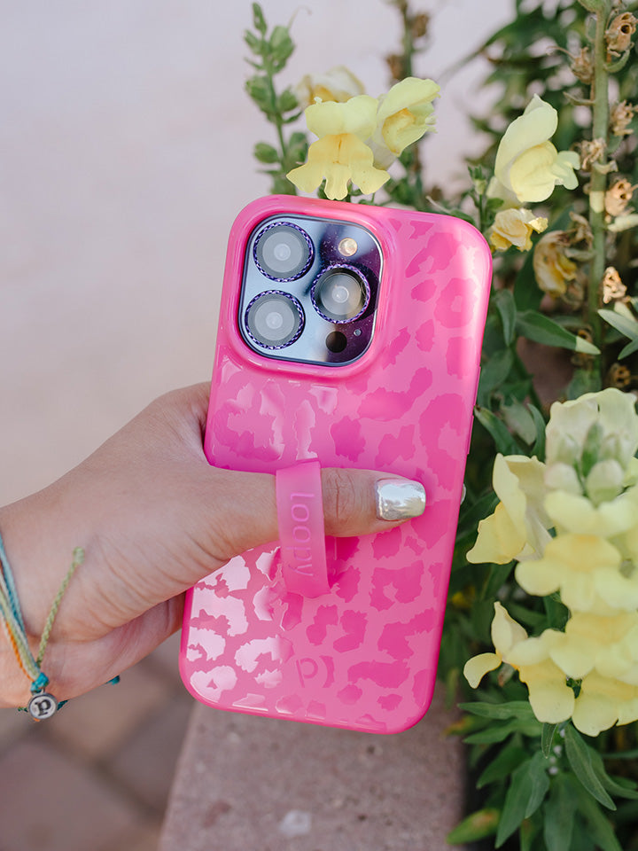 A woman holding a Hot Pink Leopard Loopy Case. || feature-media