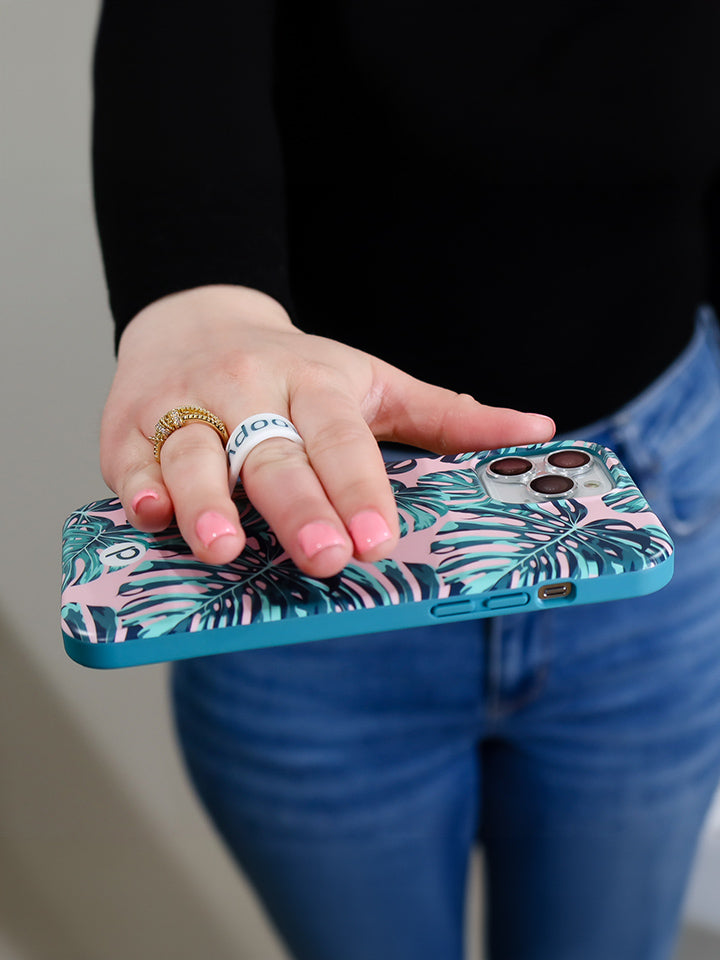 A woman holding a Pink Monstera Loopy Case. || feature-media