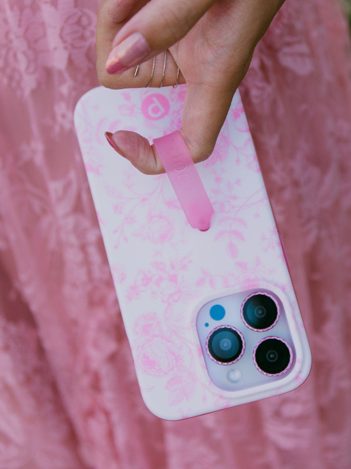 A woman holding a Pink Toile Loopy Case. || feature-media