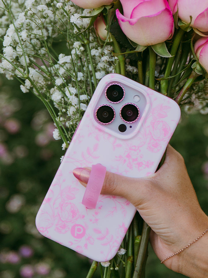 A woman holding a Pink Toile Loopy Case. || feature-media