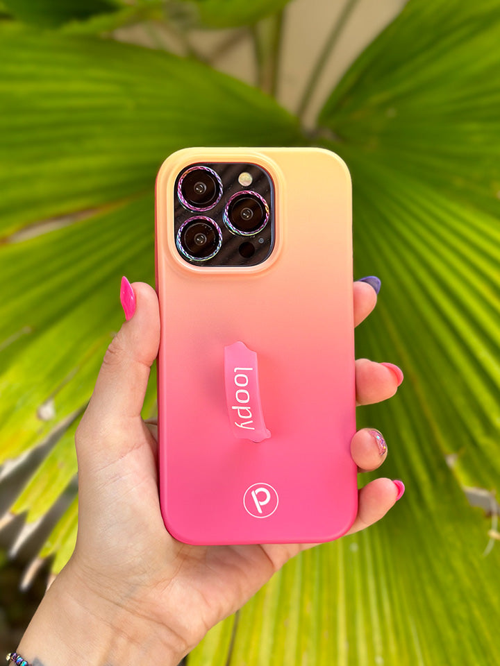 A woman holding a Pink Lemonade Ombre Loopy Case.|| feature-media