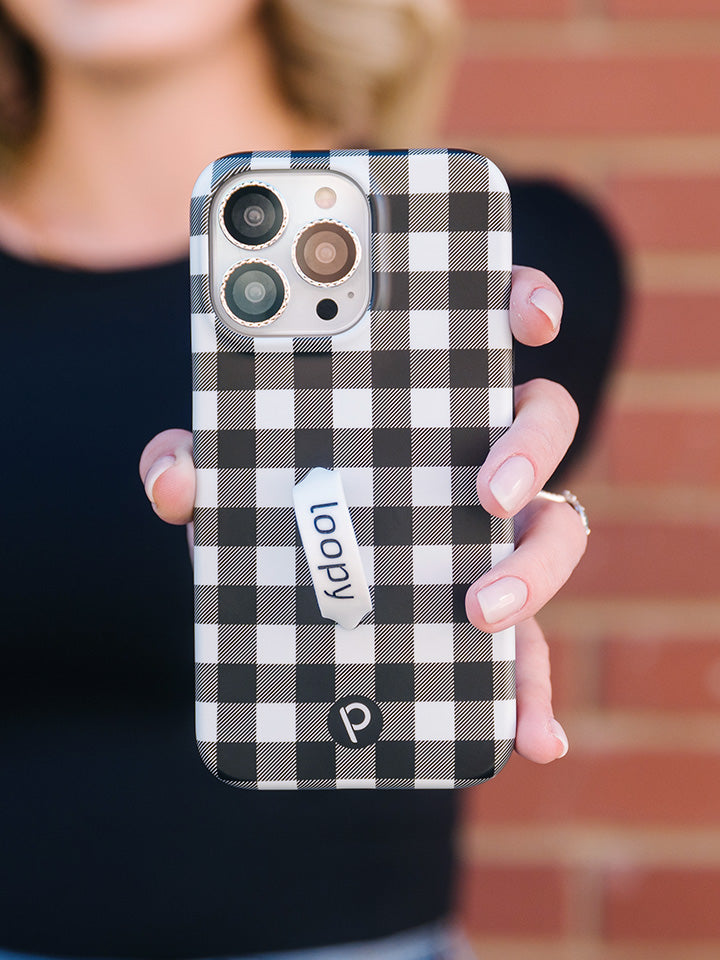 A woman holding a Plaid Loopy Case.|| feature-media