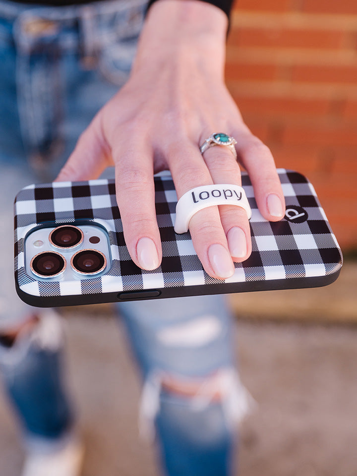 A woman holding a Plaid Loopy Case.|| feature-media