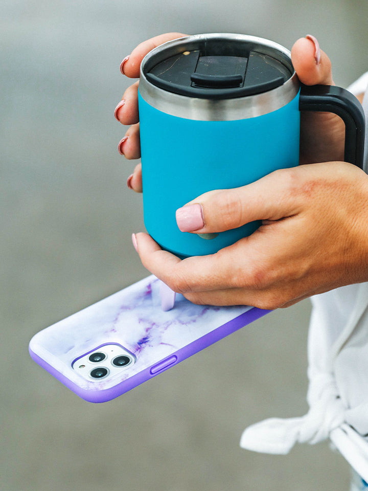 A woman holding a Purple Marble Loopy Case. || feature-media