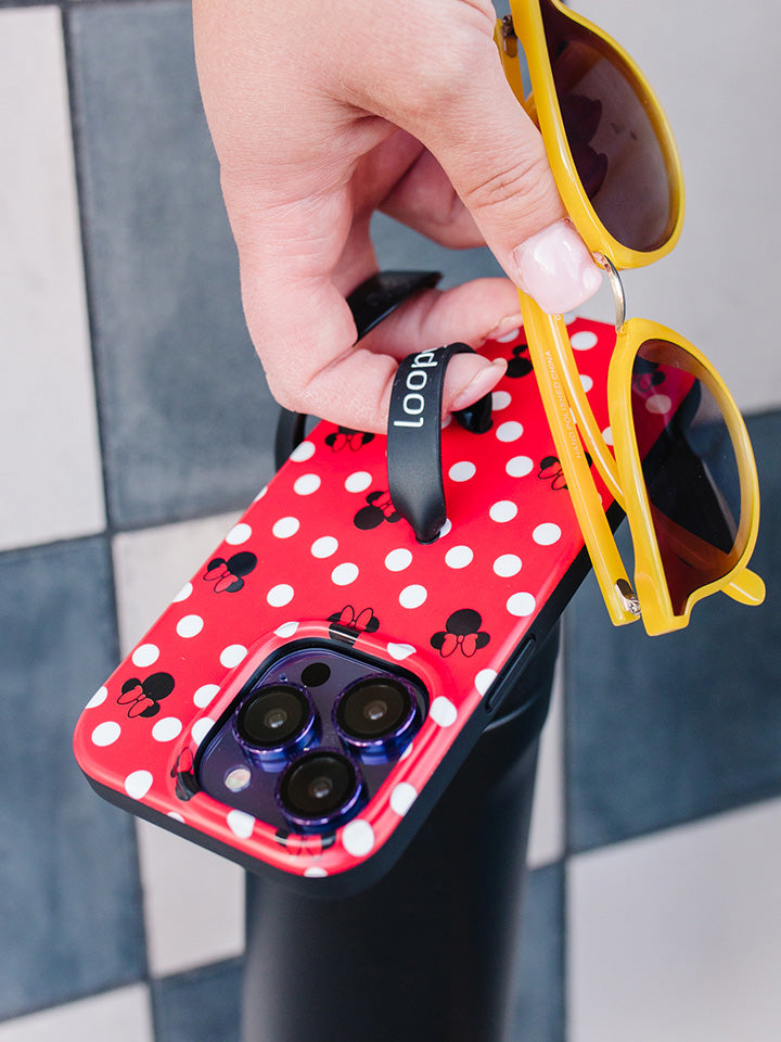 A woman holding a Red Polka Dot Minnies Loopy Case.|| feature-media