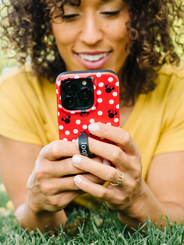 A woman holding a Red Polka Dot Minnies Loopy Case.|| feature-media