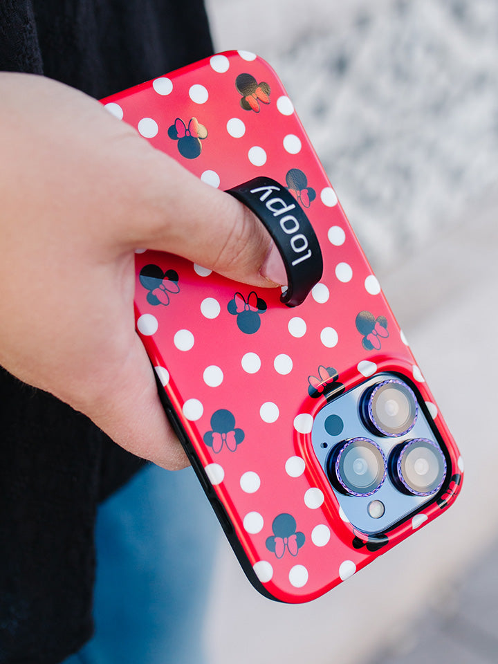 A woman holding a Red Polka Dot Minnies Loopy Case.|| feature-media