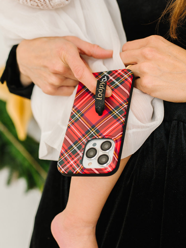 A woman holding a Red Tartan Plaid Loopy Case. || feature-media