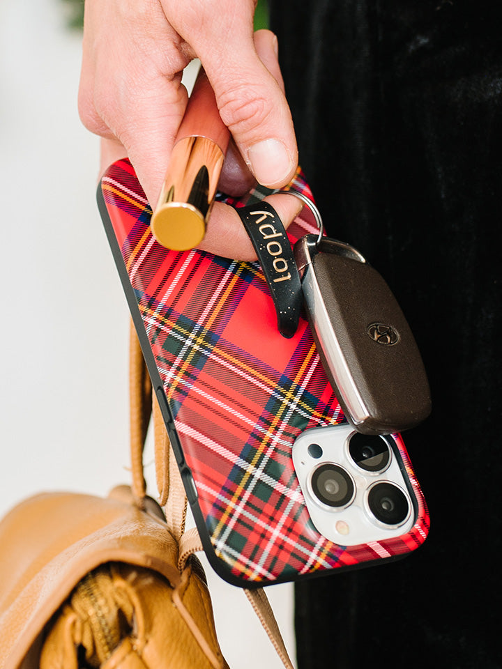 A woman holding a Red Tartan Plaid Loopy Case. || feature-media