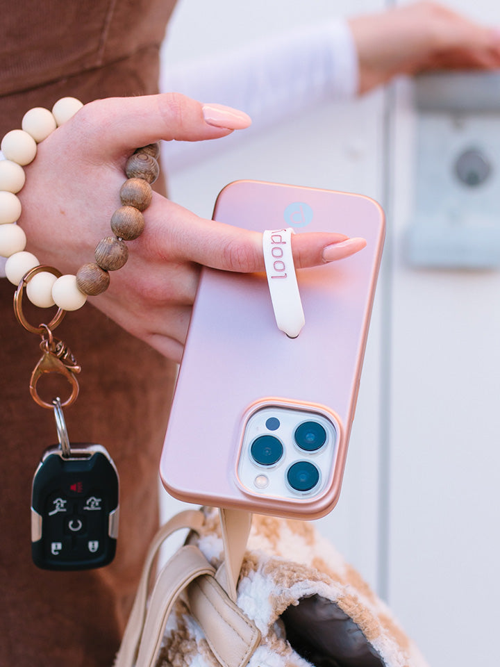 A woman holding a Rose Gold Loopy Case.|| feature-media