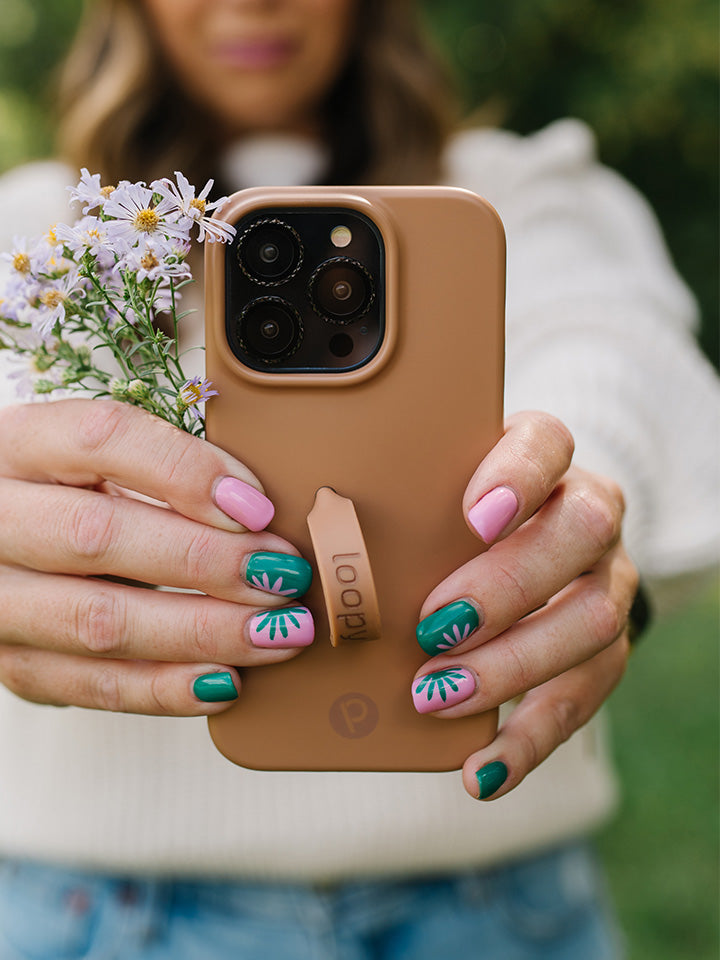 A woman holding a Saddle Brown Loopy Case.|| feature-media