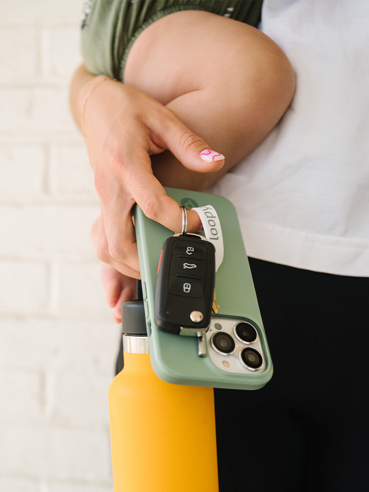 A woman holding a Sage Loopy Case.|| feature-media