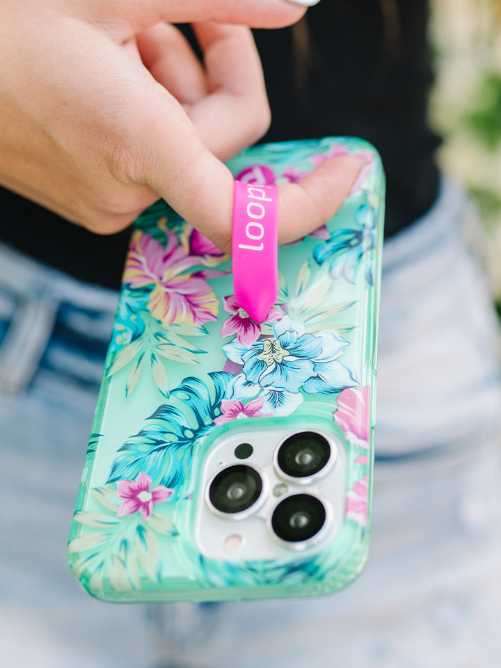 A woman holding a Clear Sea Glass Floral Loopy Case. || feature-media