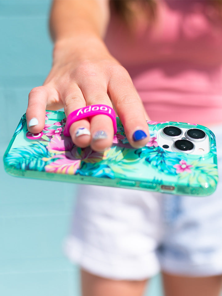 A woman holding a Clear Sea Glass Floral Loopy Case. || feature-media