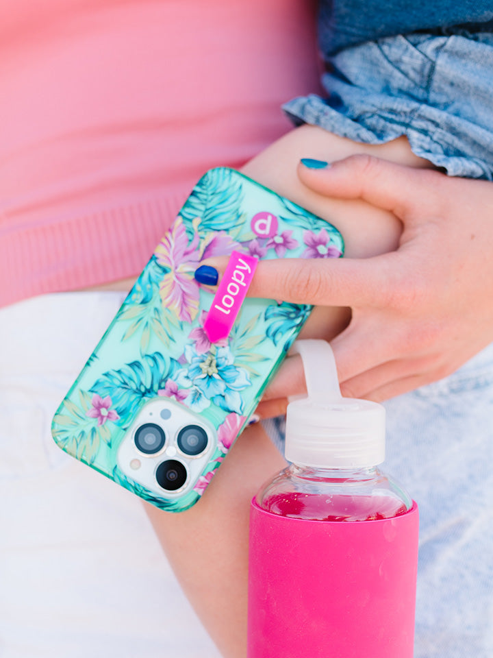 A woman holding a Clear Sea Glass Floral Loopy Case. || feature-media