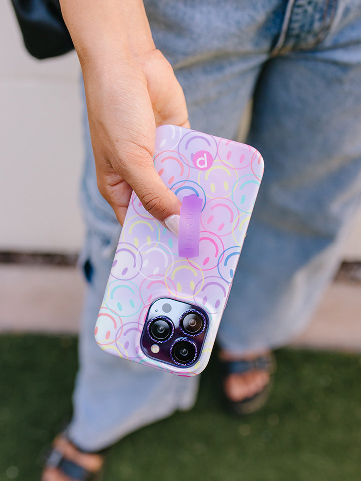 A woman holding a Smileys Loopy Case.|| feature-media