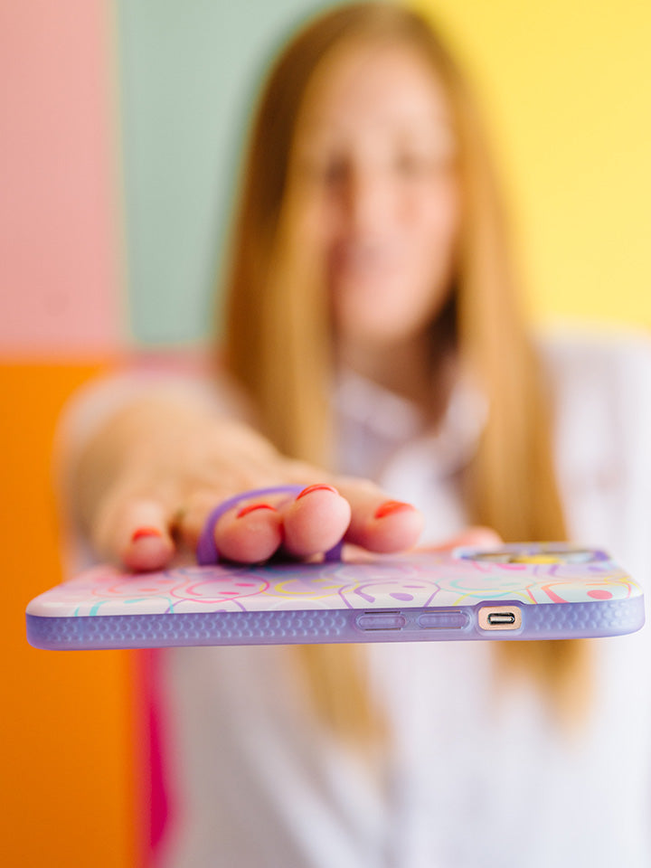 A woman holding a Smileys Loopy Case.|| feature-media