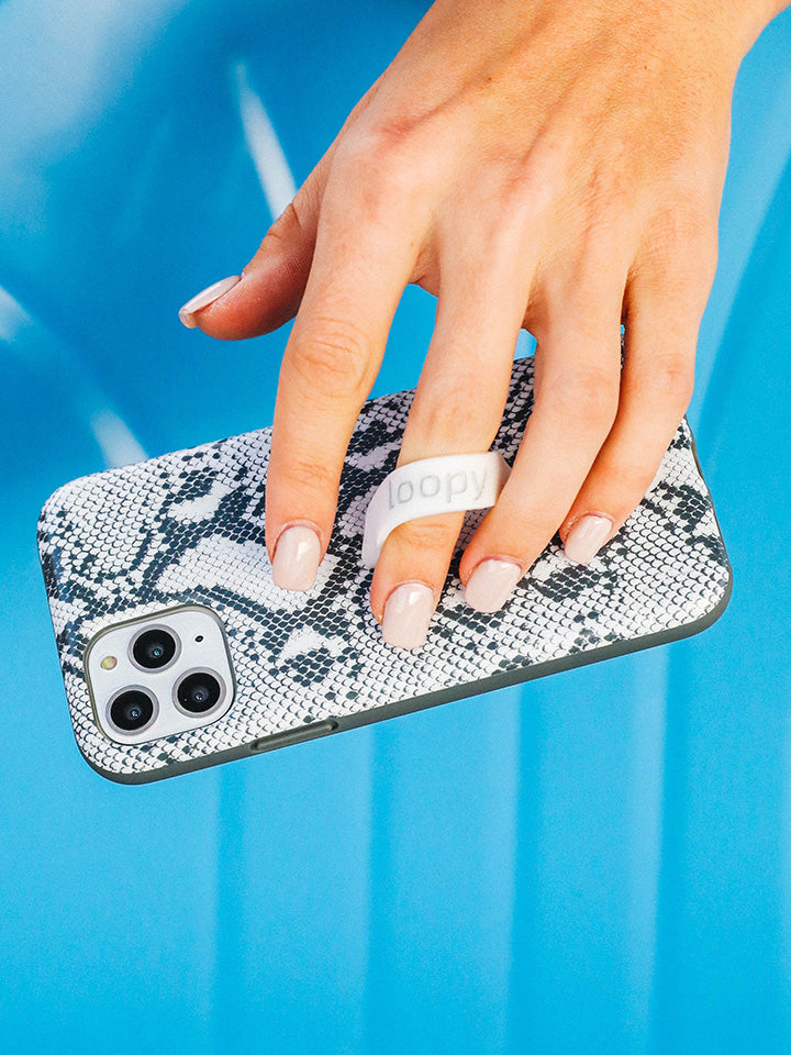 A woman holding a Snakeskin Loopy Case. || feature-media