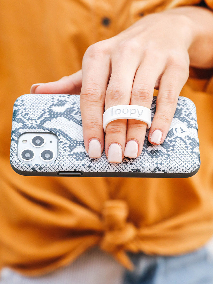 A woman holding a Snakeskin Loopy Case. || feature-media