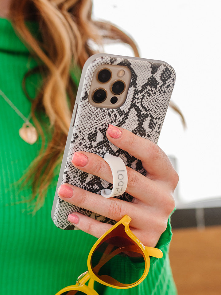 A woman holding a Snakeskin Loopy Case. || feature-media