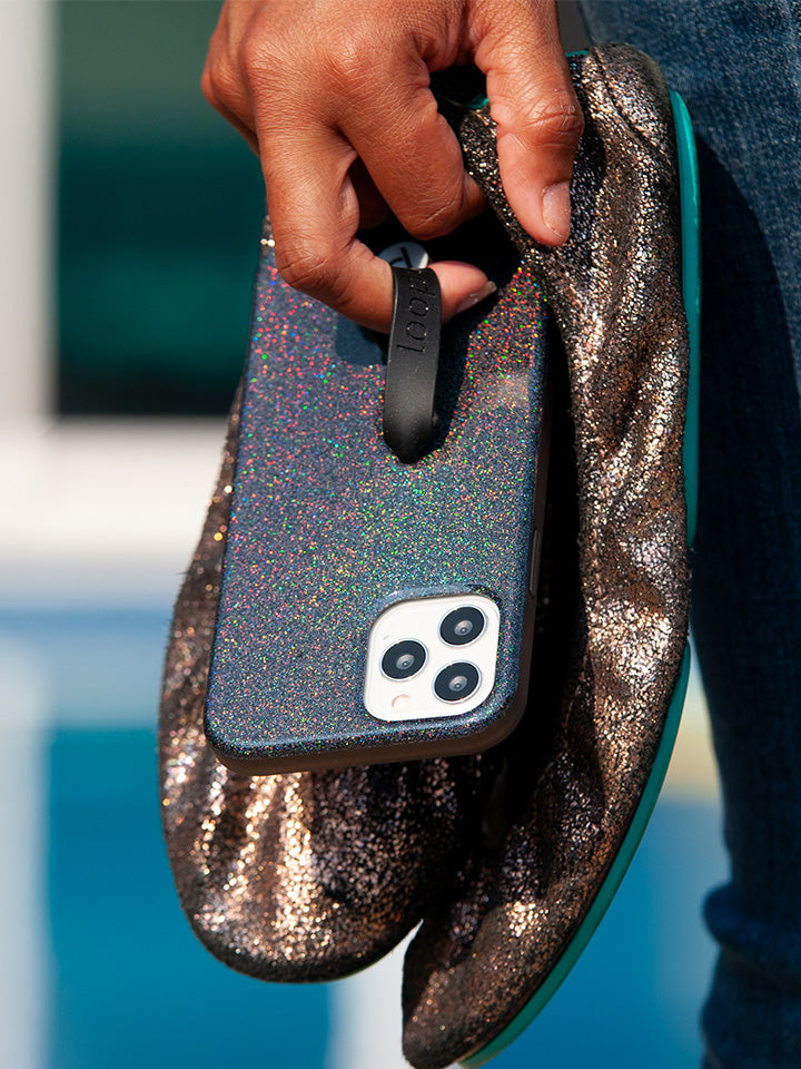 A woman holding a Sparkle Black Loopy Case.|| feature-media