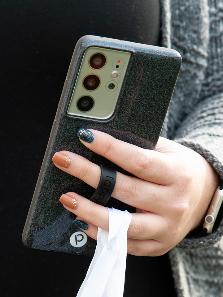 A woman holding a Sparkle Black Loopy Case.|| feature-media