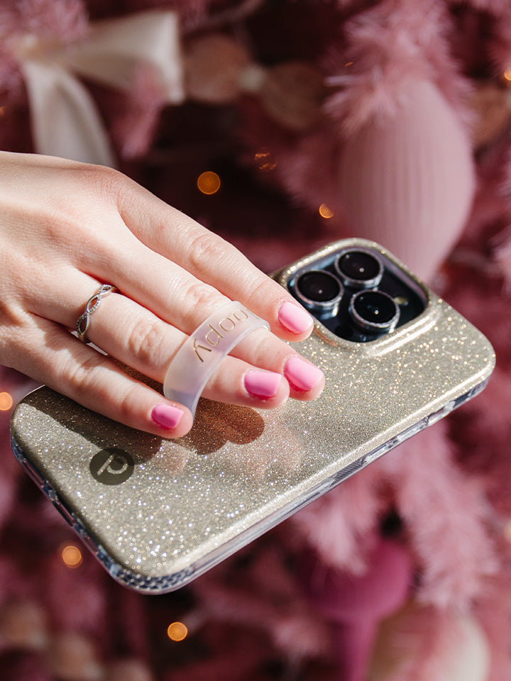 A woman holding a Champagne Sparkle Loopy Case. || feature-media