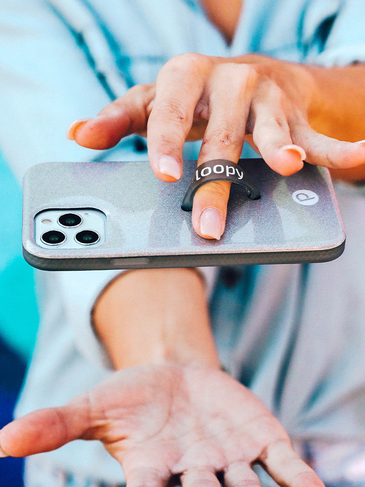 A woman holding a Sparkle Silver Loopy Case.|| feature-media