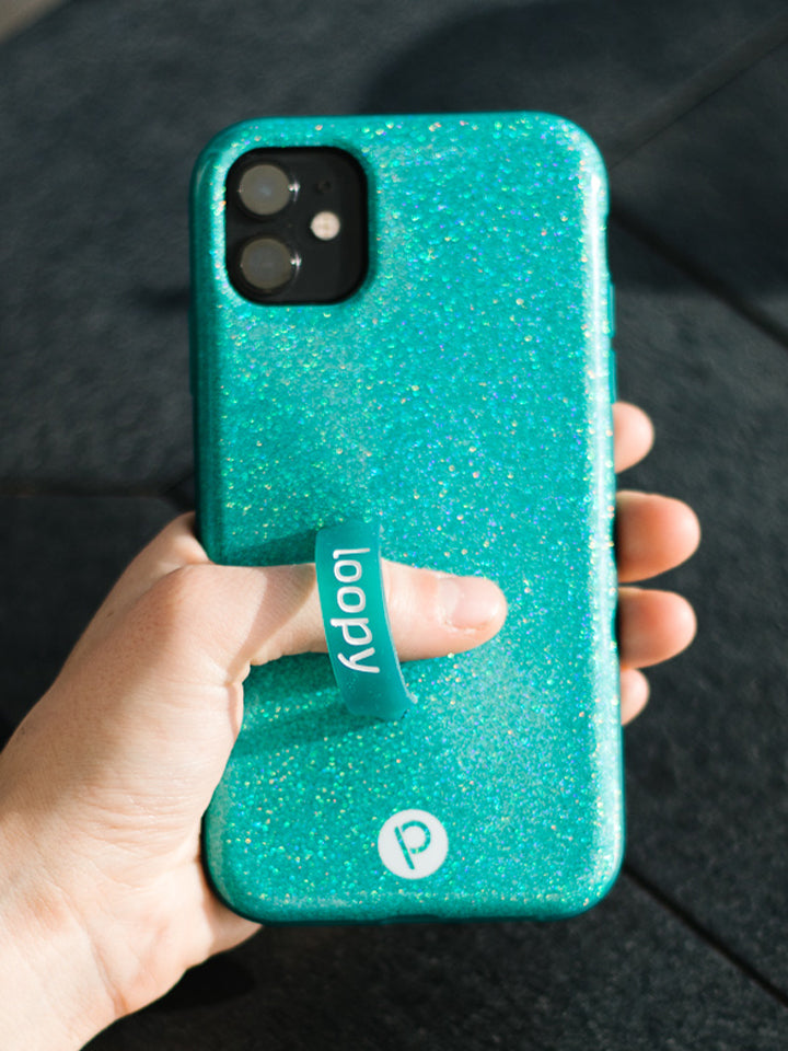 A woman holding a Sparkle Turquoise Loopy Case. || feature-media