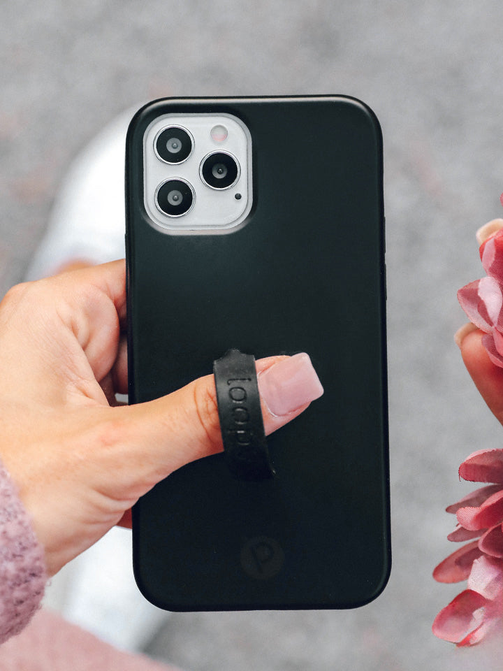 A woman holding a Stealth Black Loopy Case. || feature-media