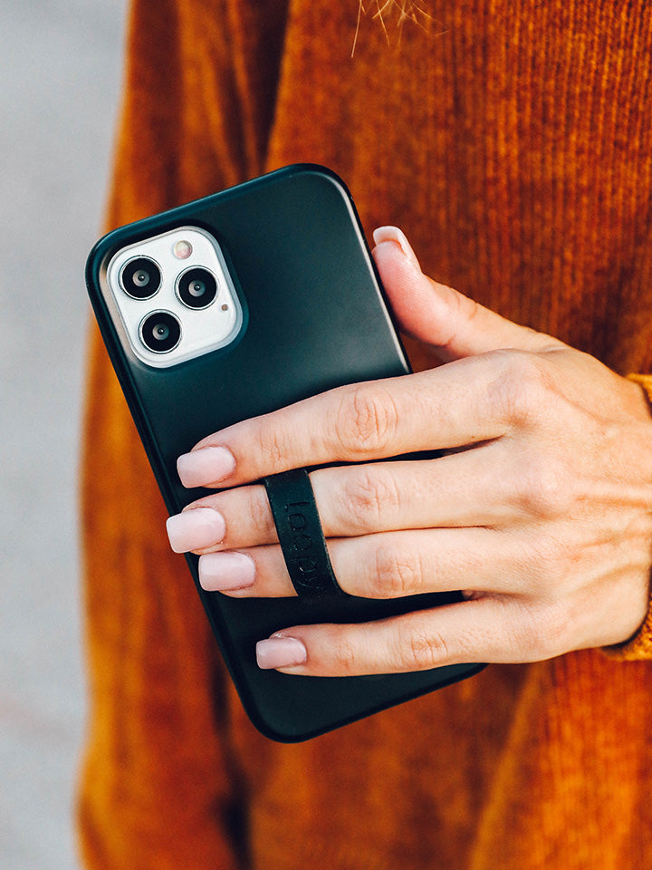 A woman holding a Stealth Black Loopy Case. || feature-media