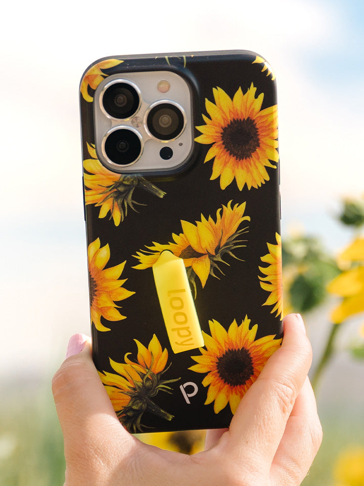 A woman holding a Sunflowers Loopy Case. || feature-media