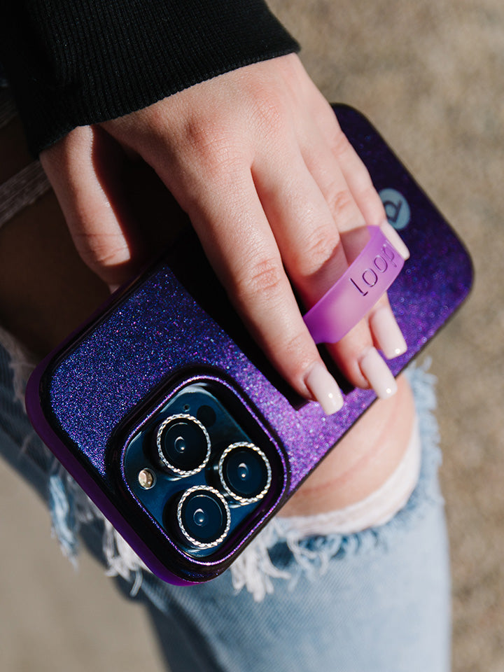 A woman holding a Supernova Shimmer Loopy Case.|| feature-media