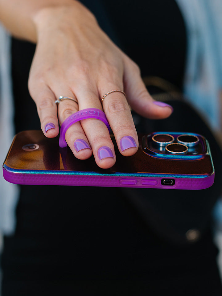 A woman holding a Supernova Shimmer Loopy Case.|| feature-media