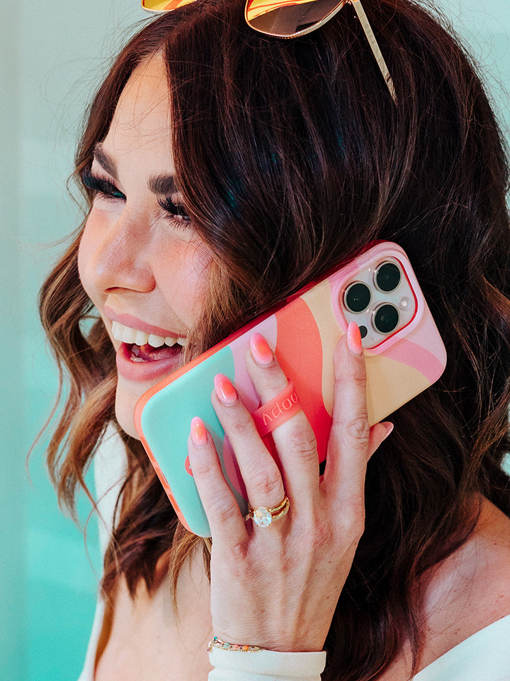 Amber Massey talking on the phone while holding a Sweet Sorbet Loopy Case. || feature-media