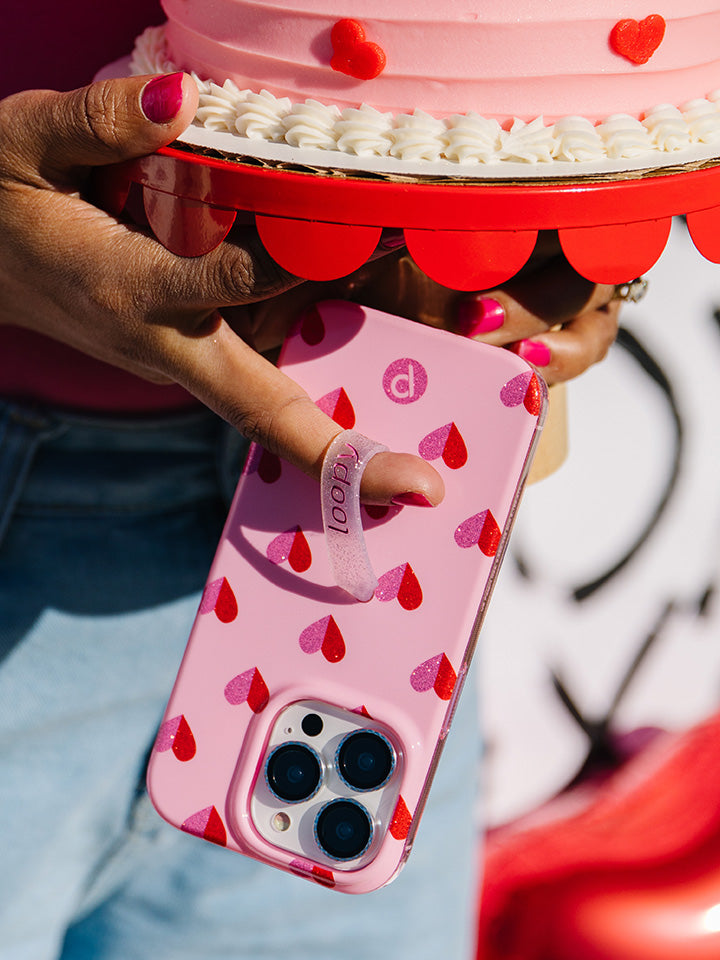  A woman holding a Sweetheart Sparkle Loopy Case.|| feature-media