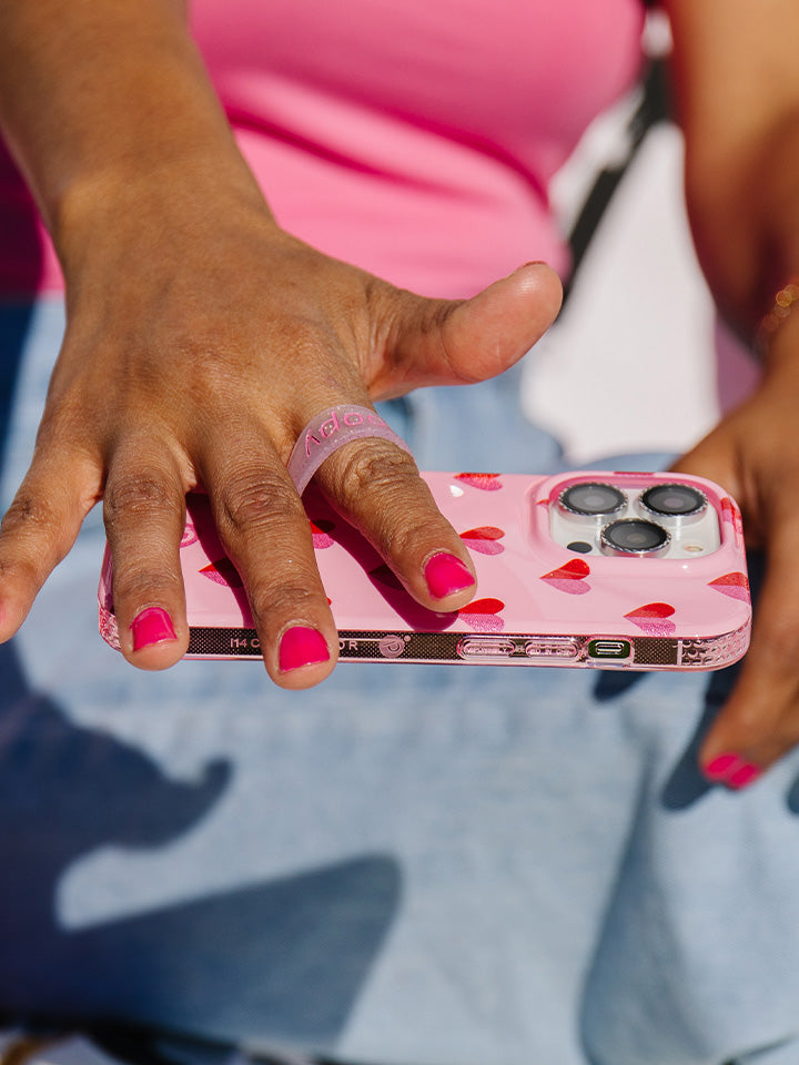 A woman holding a Sweetheart Sparkle Loopy Case. || feature-media