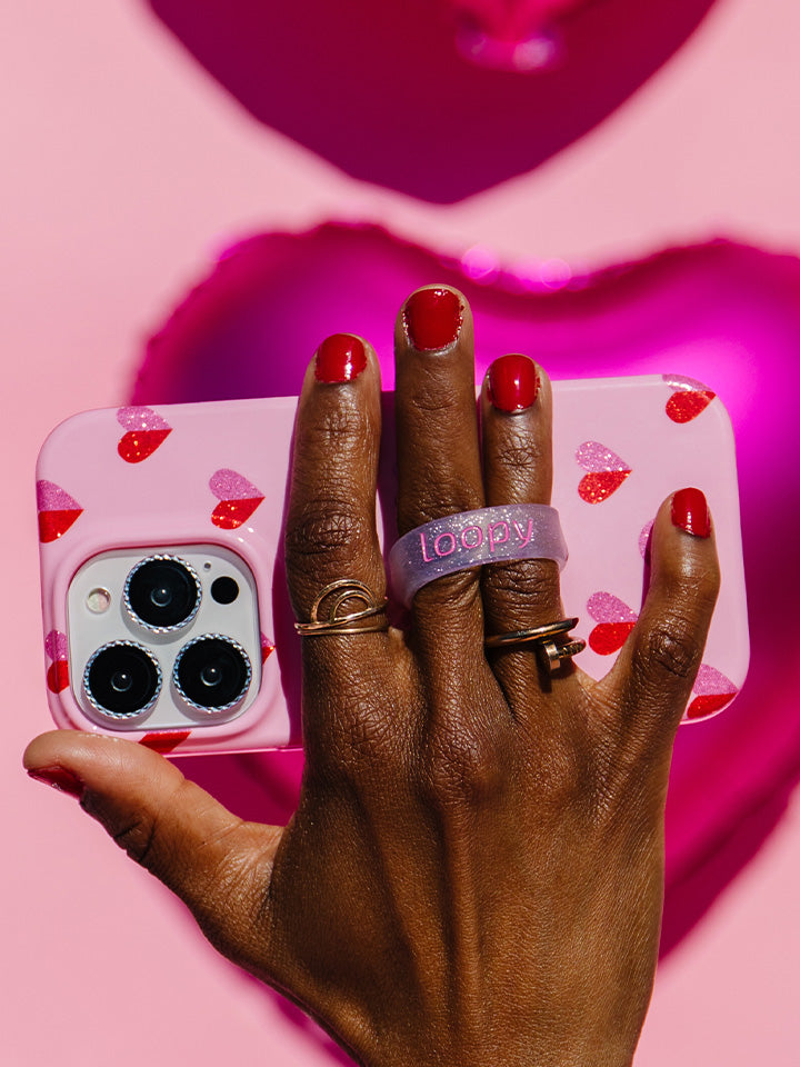 A woman holding a Sweetheart Sparkle Loopy Case.|| feature-media