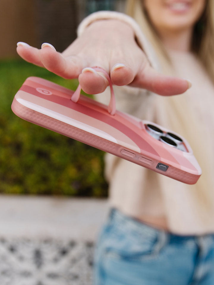 A woman holding a Terracotta Dream Loopy Case. || feature-media