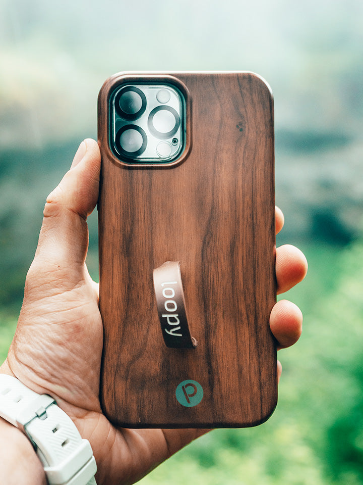 A man holding a Teakwood Loopy Case. || feature-media