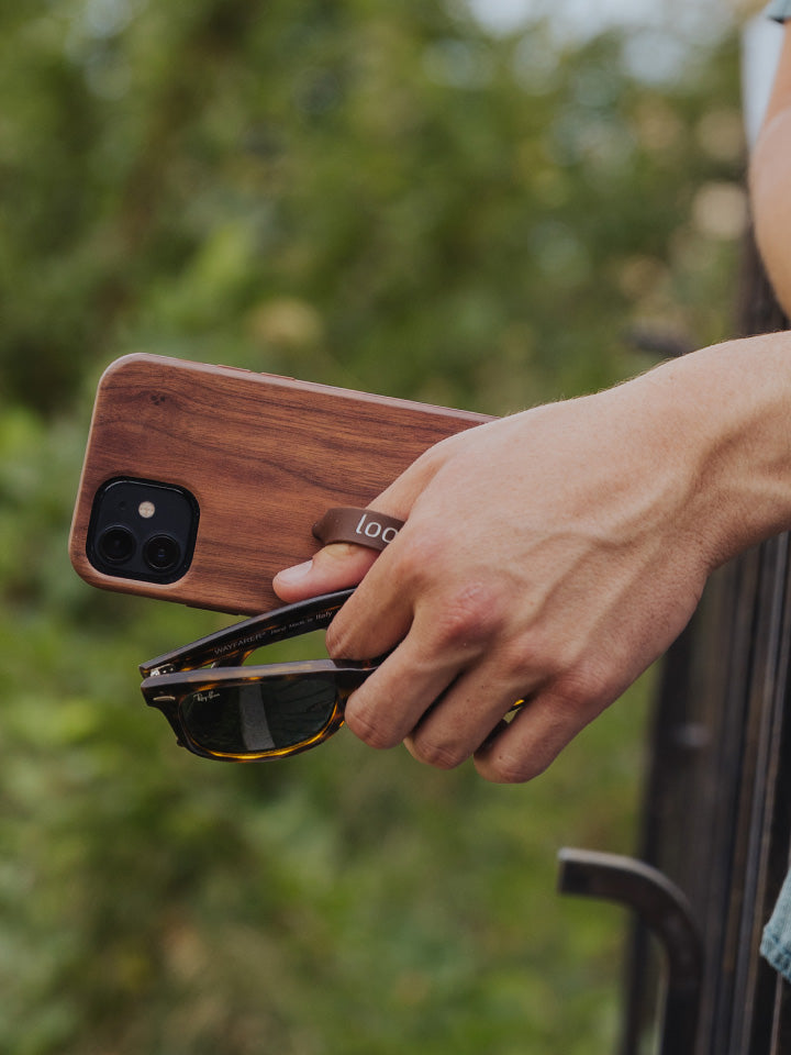 A man holding a Teakwood Loopy Case. || feature-media