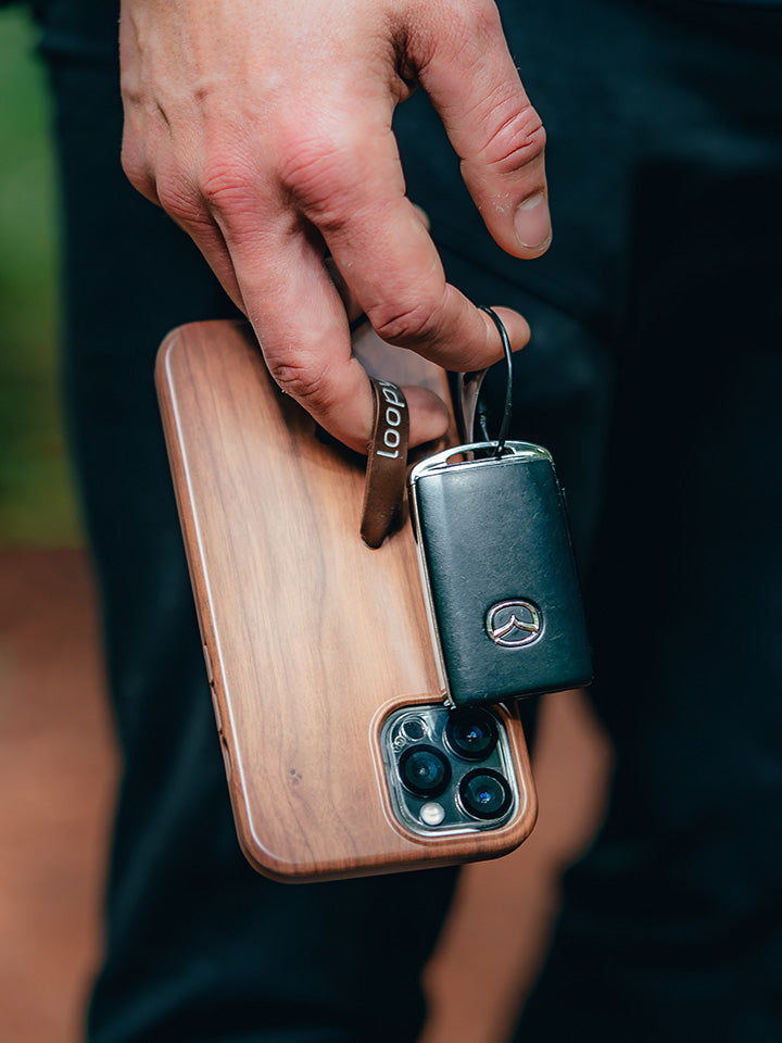 A man holding a Teakwood Loopy Case. || feature-media