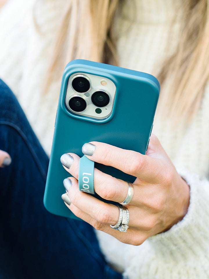 A woman holding a Teal Loopy Case.|| feature-media