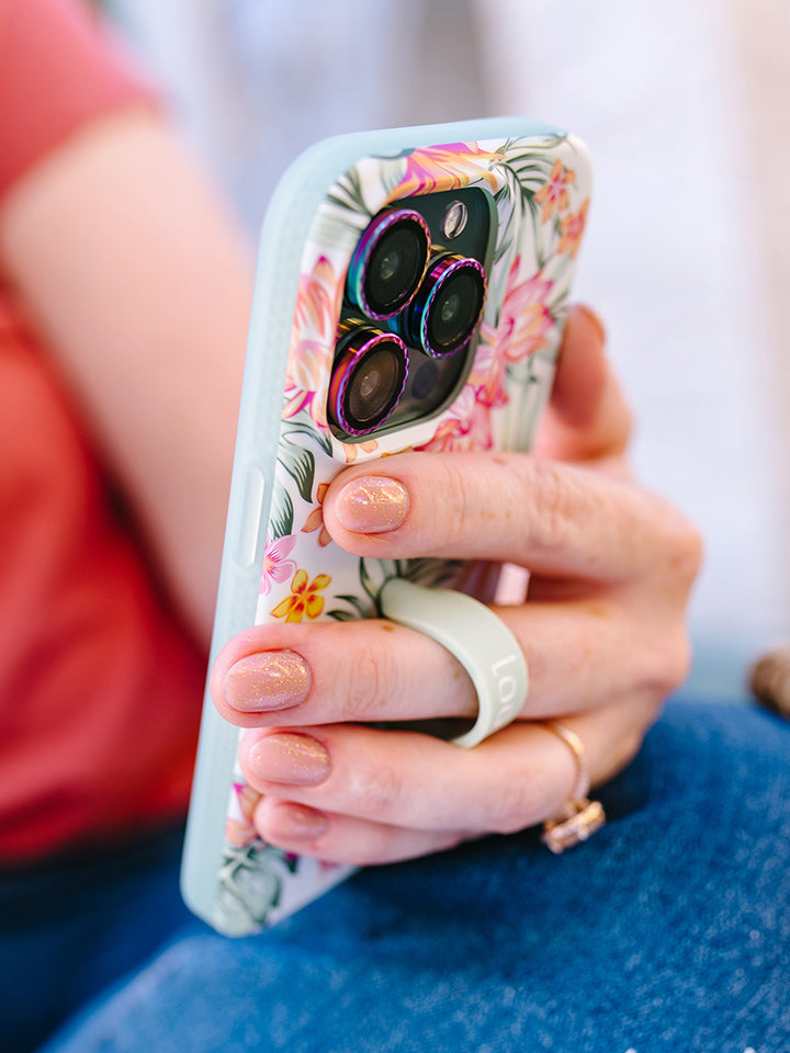 A woman holding a Tropical Blooms Loopy Case.|| feature-media